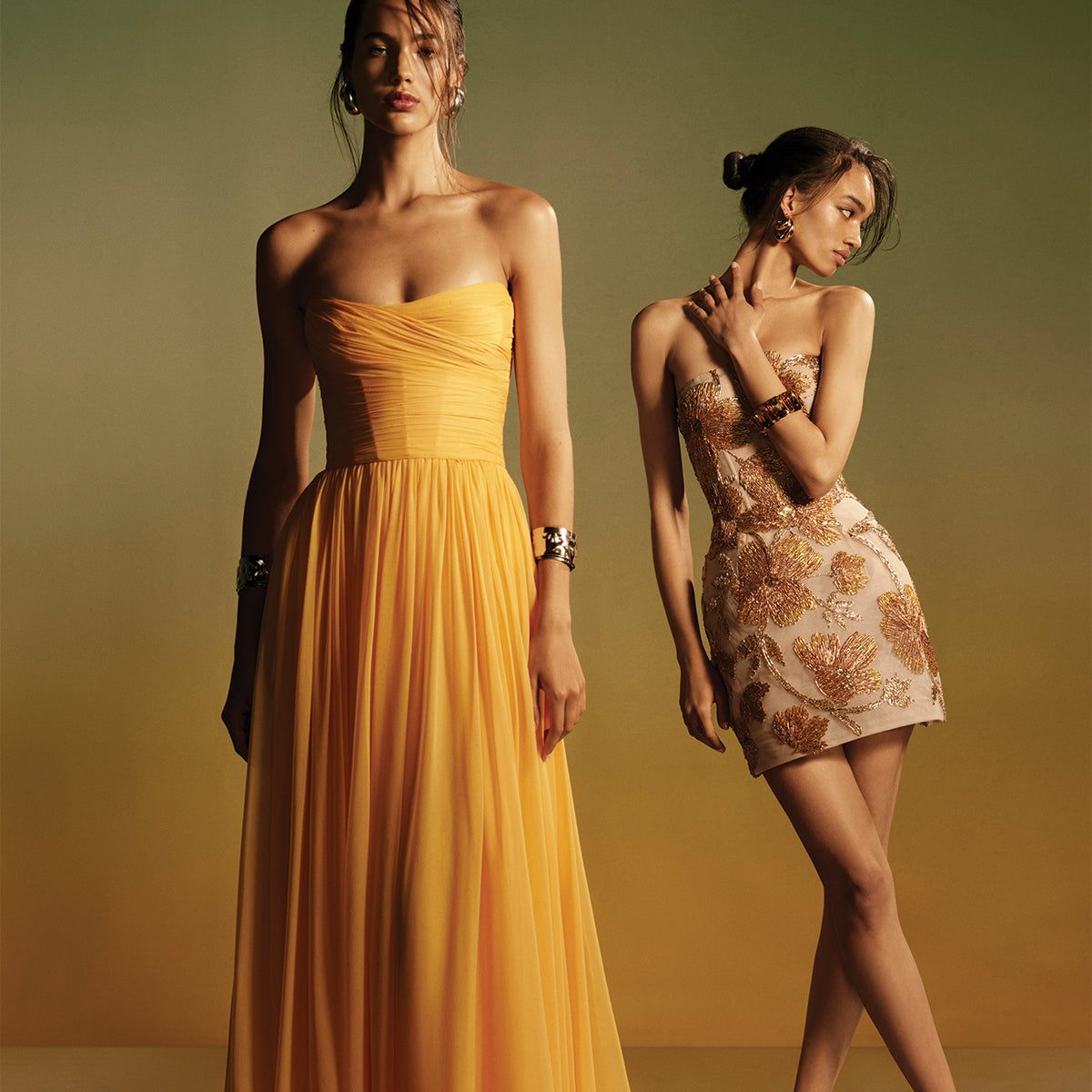 Monique Lhuillier Spring 2026 - model on left wearing Mango chiffon strapless gown, model on right wearing gold embroidered mini dress -lookbook