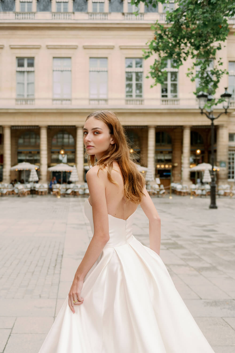 Woman wearing Monique Lhuillier Spring 2024 Bliss white strapless mikado BL24101 ballgown
