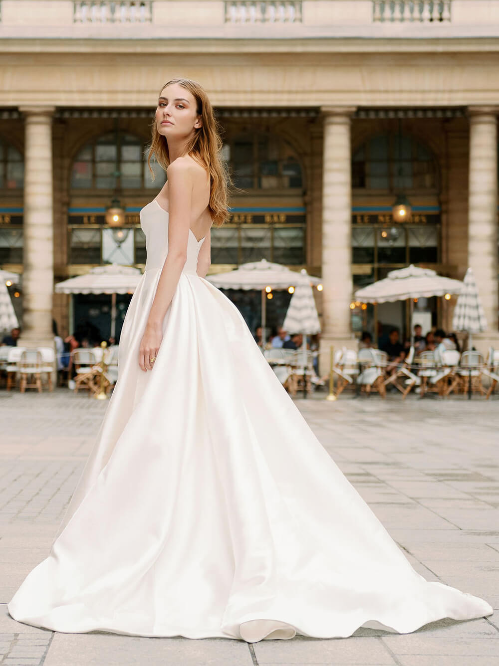 Woman wearing Monique Lhuillier Spring 2024 Bliss white strapless mikado BL24101 ballgown