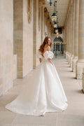 Woman wearing Monique Lhuillier Fall 2023 Bliss white strapless sweetheart BL23201 ballgown with tufted sleeves