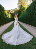 Woman wearing Monique Lhuillier Fall 2024 strapless draped bodice white printed organza Breathless ballgown with long train