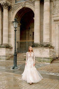 Woman wearing Monique Lhuillier Fall 2023 Bliss long sleeve v-neck white embroidered tulle a-line BL23203 gown