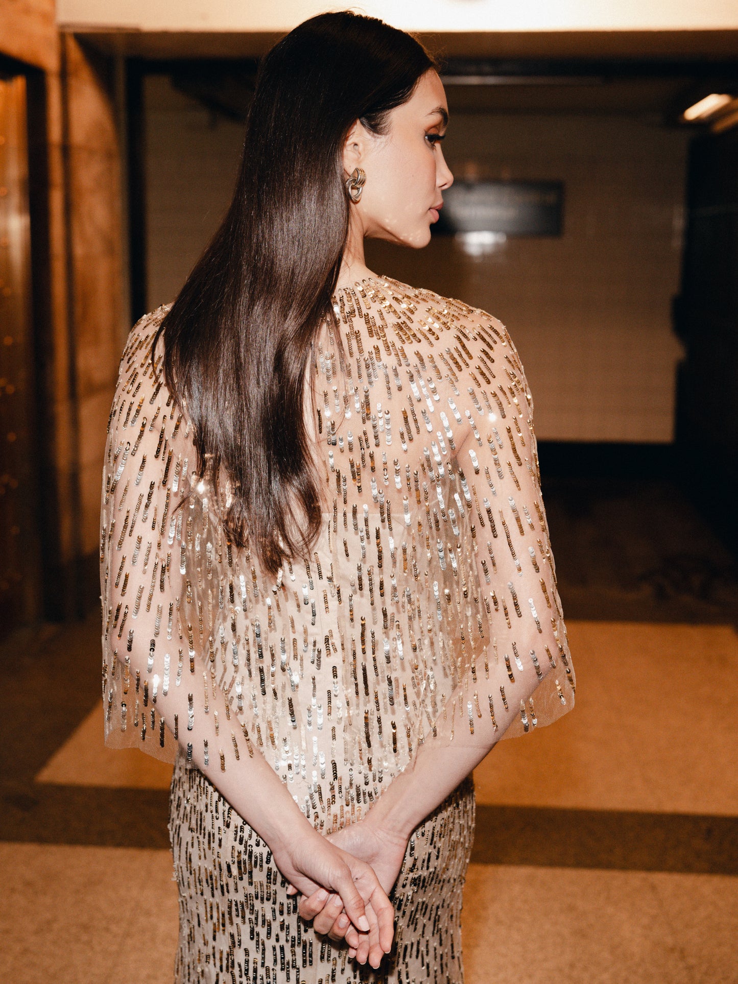 Monique Lhuillier Fall 2025 gold sequin embroidered tulle gown with integral capelet - lookbook.