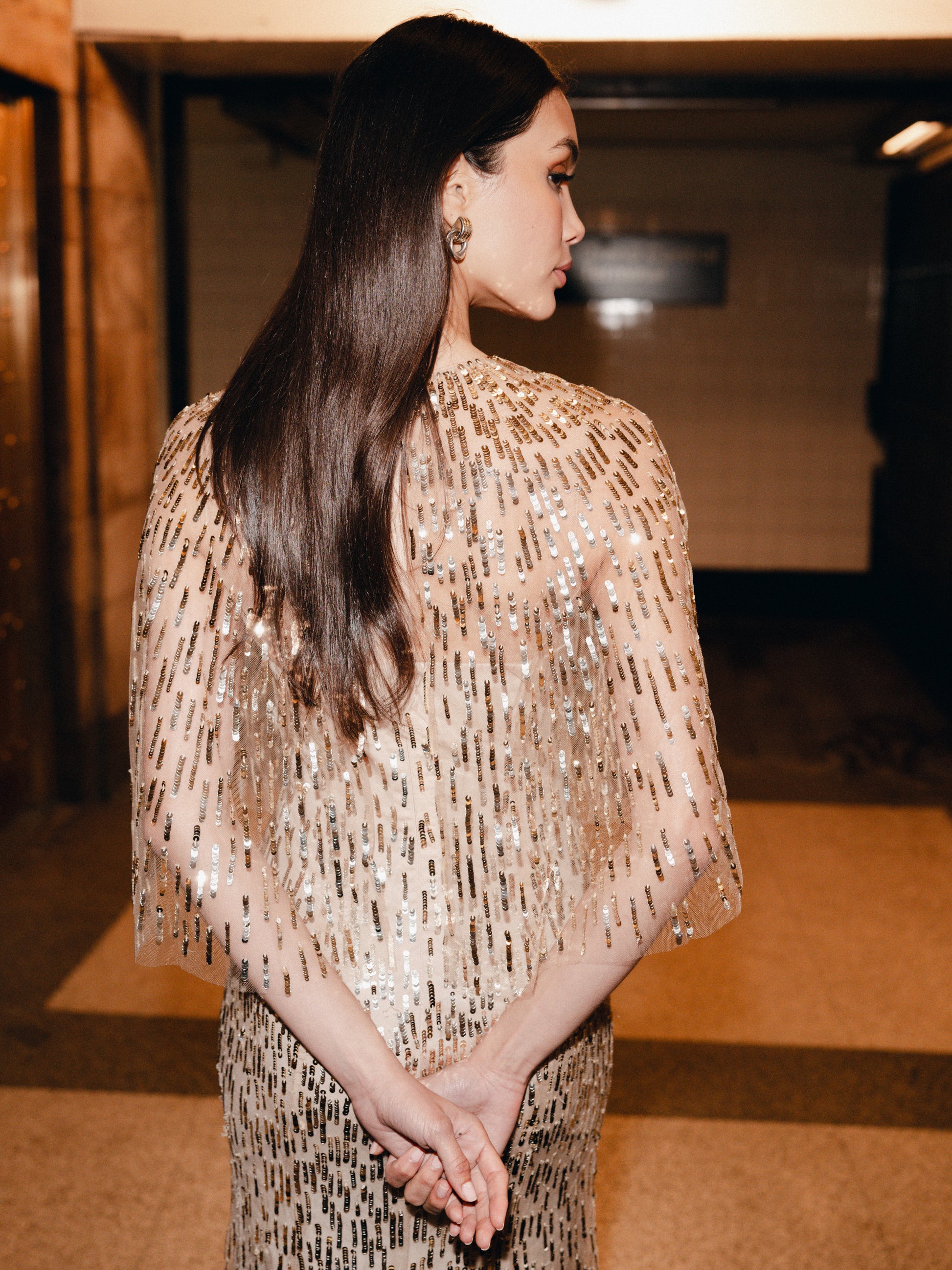 Monique Lhuillier Fall 2025 gold sequin embroidered tulle gown with integral capelet - lookbook.