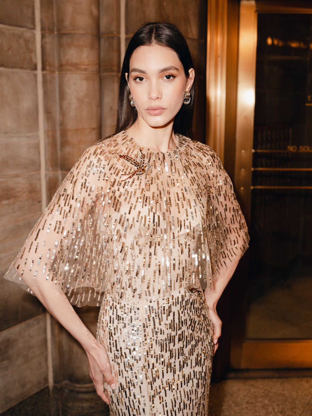 Monique Lhuillier Fall 2025 gold sequin embroidered tulle gown with integral capelet - lookbook.