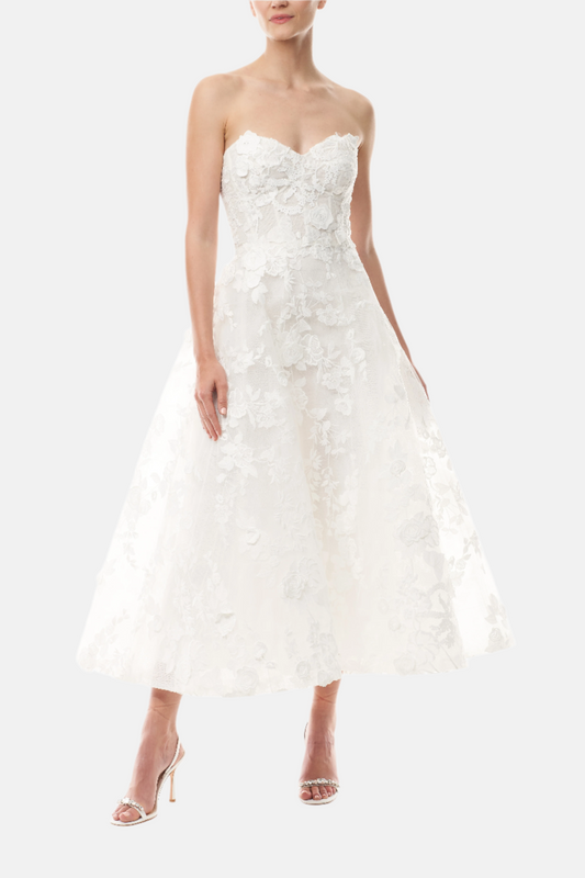 Monique Lhuillier Fall 2024 tea-length, strapless dress in silk white3D lace with full skirt and fitted sweetheart bodice - front.
