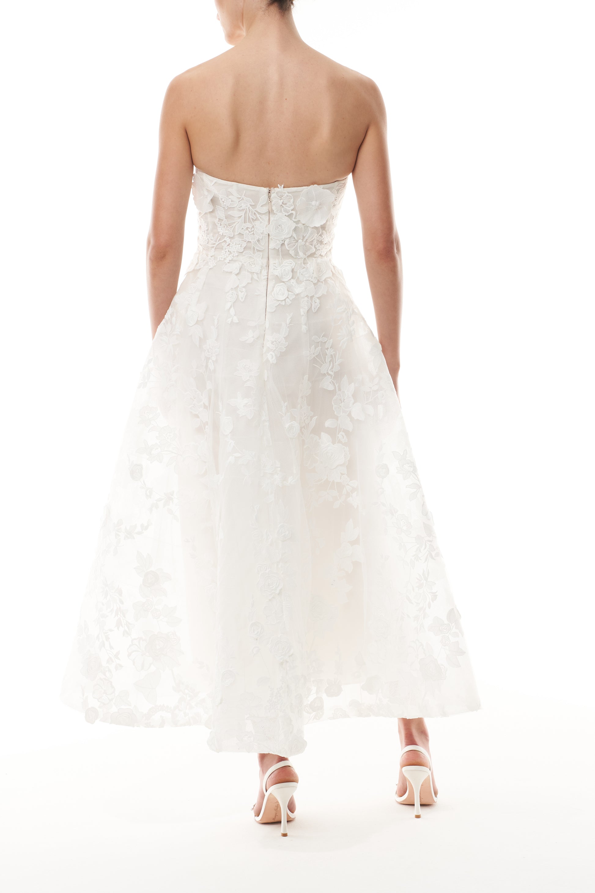 Monique Lhuillier Fall 2024 tea-length, strapless dress in silk white3D lace with full skirt and fitted sweetheart bodice - back.
