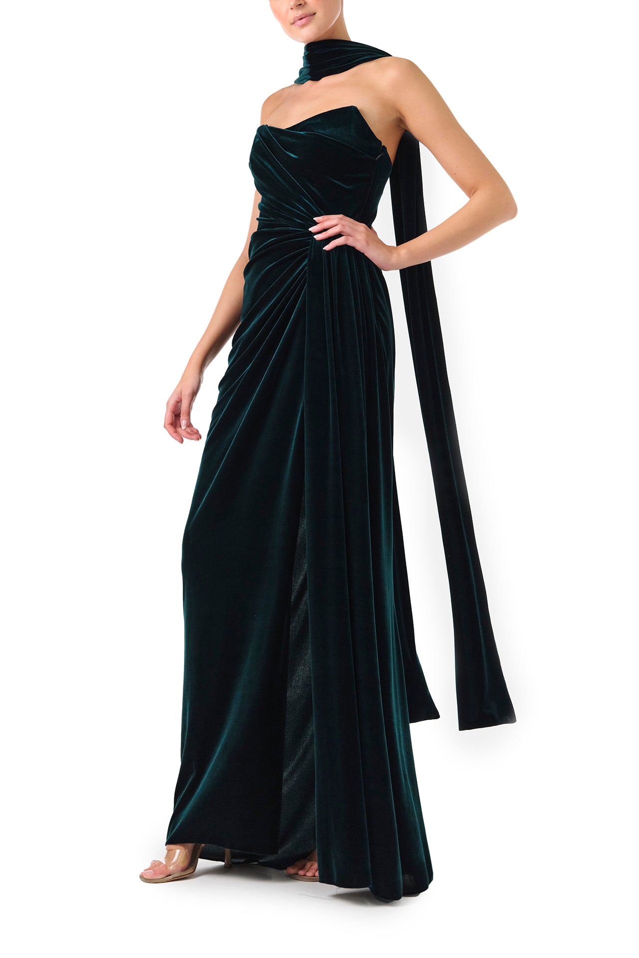 Monique Lhuillier Fall 2024 Strapless, draped column gown with scarf and high leg slit in Dark Teal stretch velour - left side.