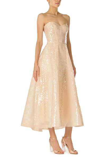 Monique Lhuillier Spring 2025 strapless, tea-length dress with sweetheart neckline in prosecco colored sequins - side.