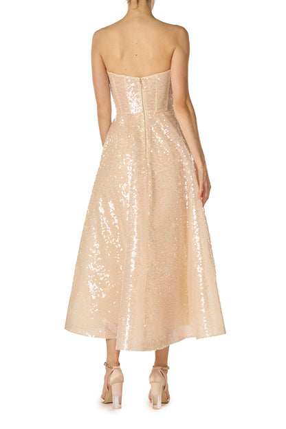 Monique Lhuillier Spring 2025 strapless, tea-length dress with sweetheart neckline in prosecco colored sequins -  back.
