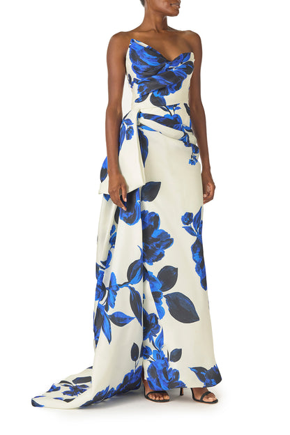 Monique Lhuillier Spring 2025 Strapless, column gown with asymmetric neckline, tufted draping and sweeping side train in Nautical Blue Floral printed gazar - right side.