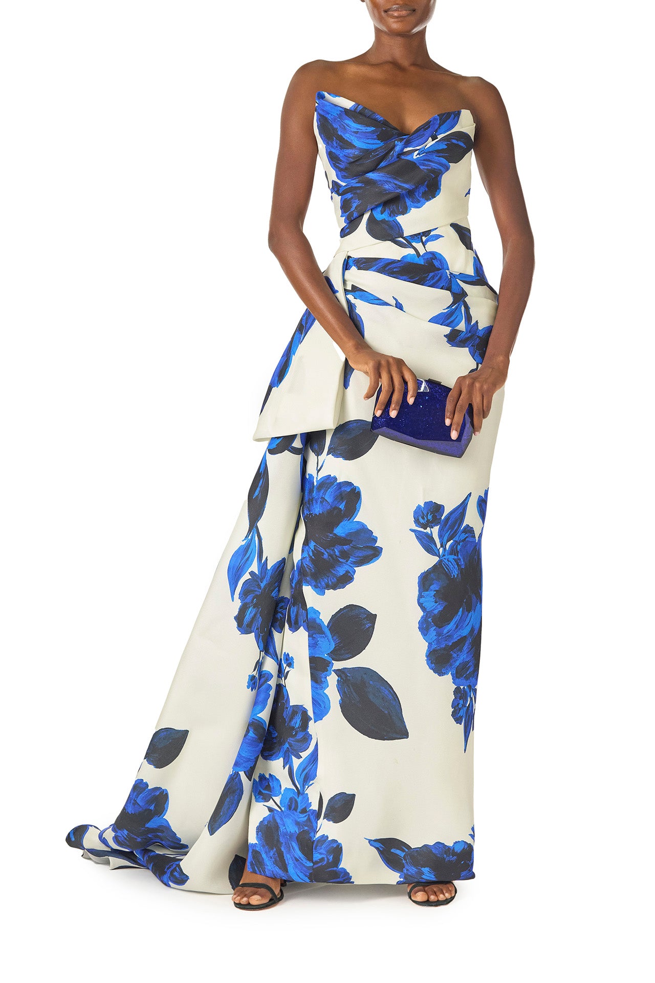 Monique Lhuillier Spring 2025 Strapless, column gown with asymmetric neckline, tufted draping and sweeping side train in Nautical Blue Floral printed gazar - front with Dasha blue handbag.