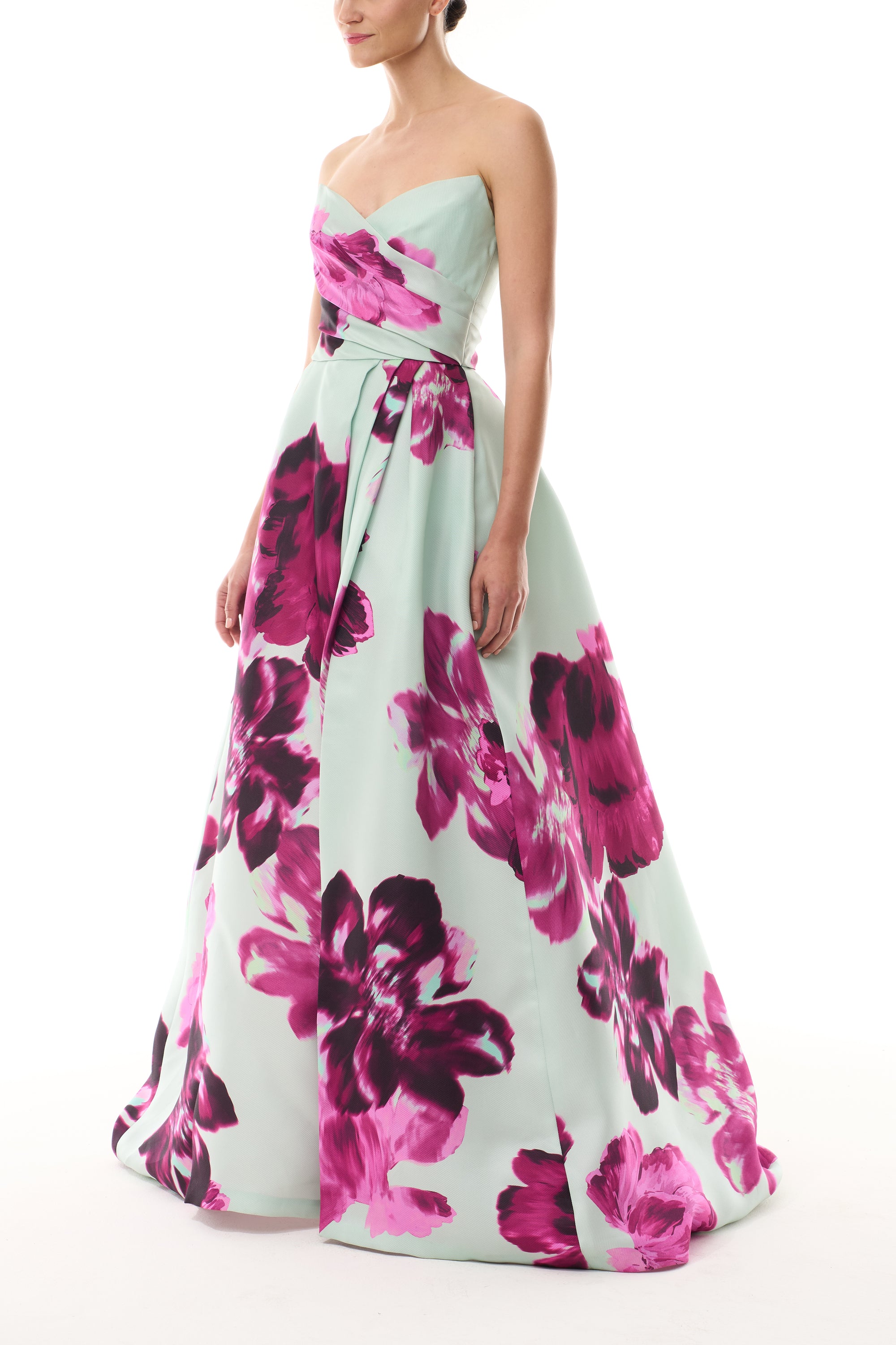 Monique Lhuillier Fall 2025 strapless ballgown with high leg slit and pockets in electric floral printed gazar - side.