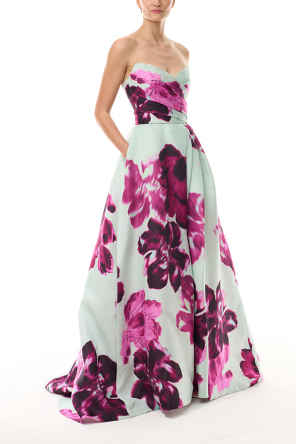 Monique Lhuillier Fall 2025 strapless ballgown with high leg slit and pockets in electric floral printed gazar - side.