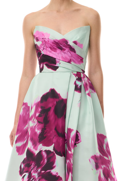 Monique Lhuillier Fall 2025 strapless ballgown with high leg slit and pockets in electric floral printed gazar - fabric.