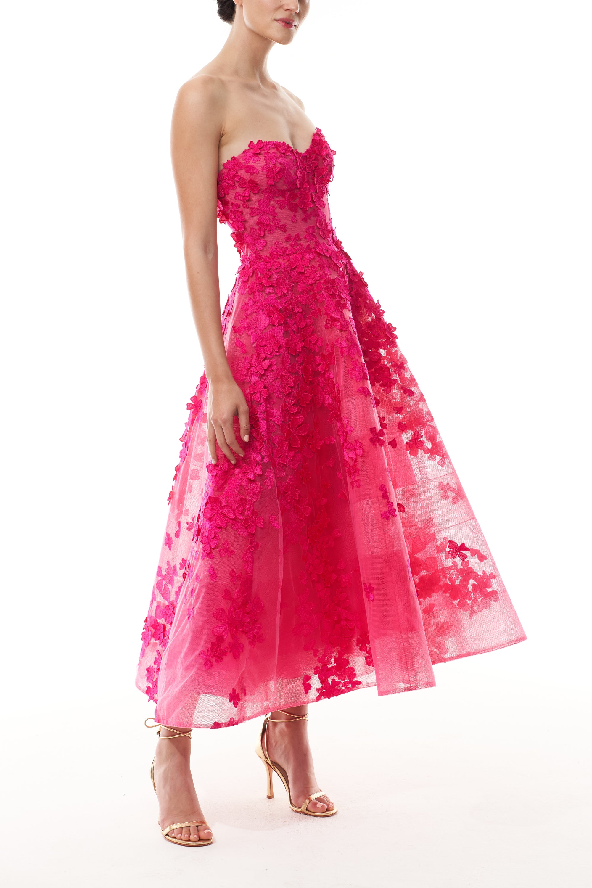 Monique Lhuillier Fall 2026 strapless, tea-length dress with sweetheart neckline in Cerise colored embroidered lace - side.