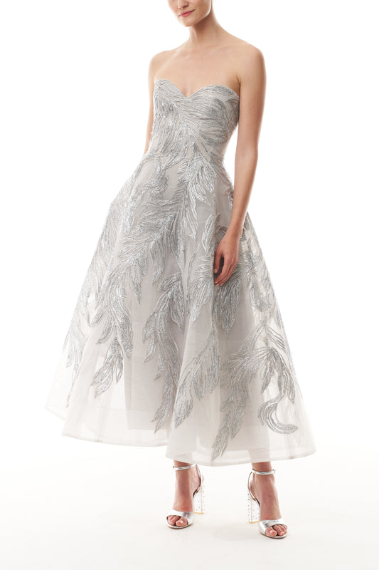 Monique Lhuillier Fall 2025 strapless dress with tea-length skirt and sweetheart neckline in silver feather embroidery - front.