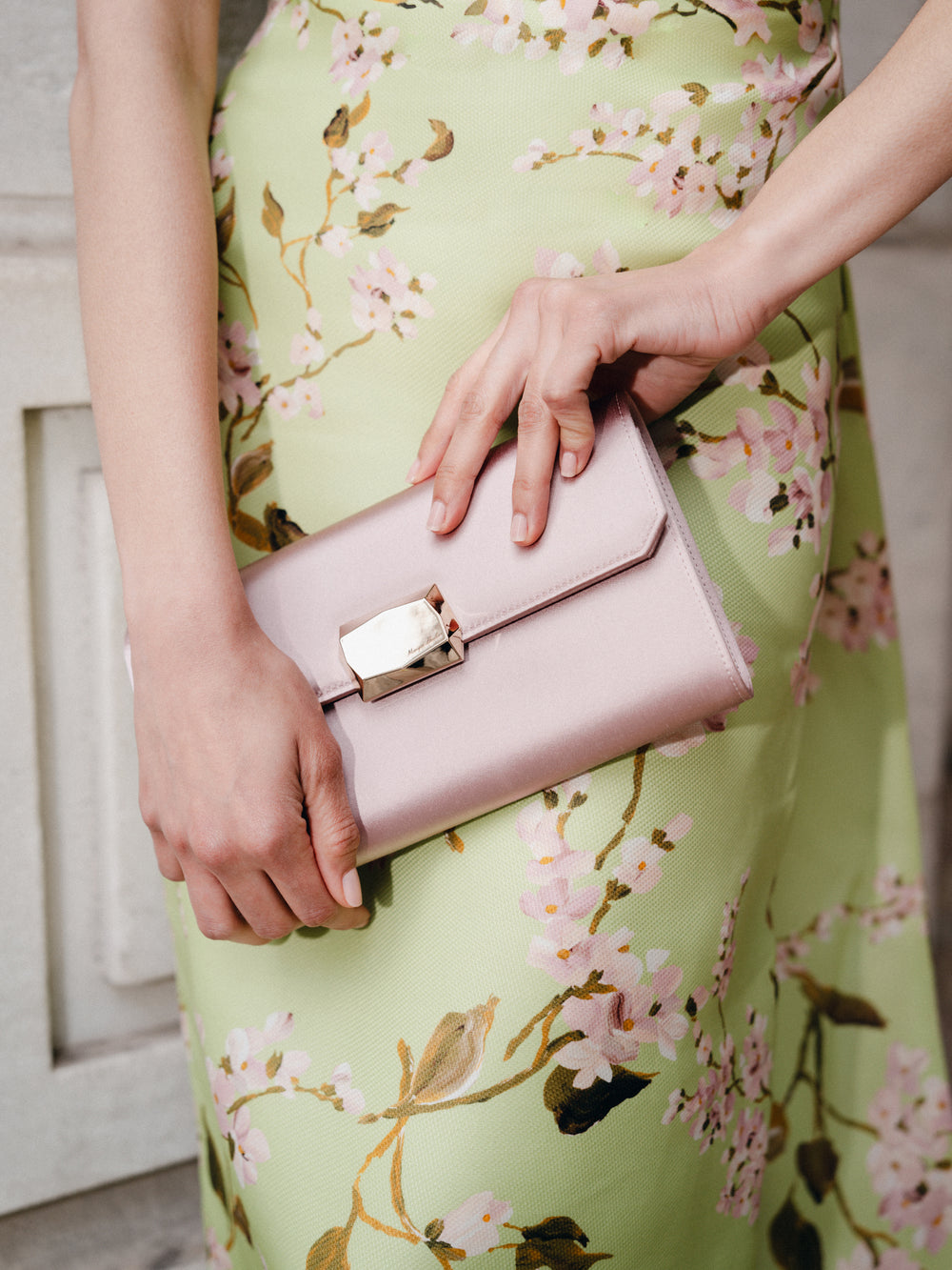 Monique Lhuillier Fall 2025  Draped Bodice Column Gown with Train in Celedon/Multi Wisteria Printed Gazar - lookbook photo with Pink Delphine clutch.