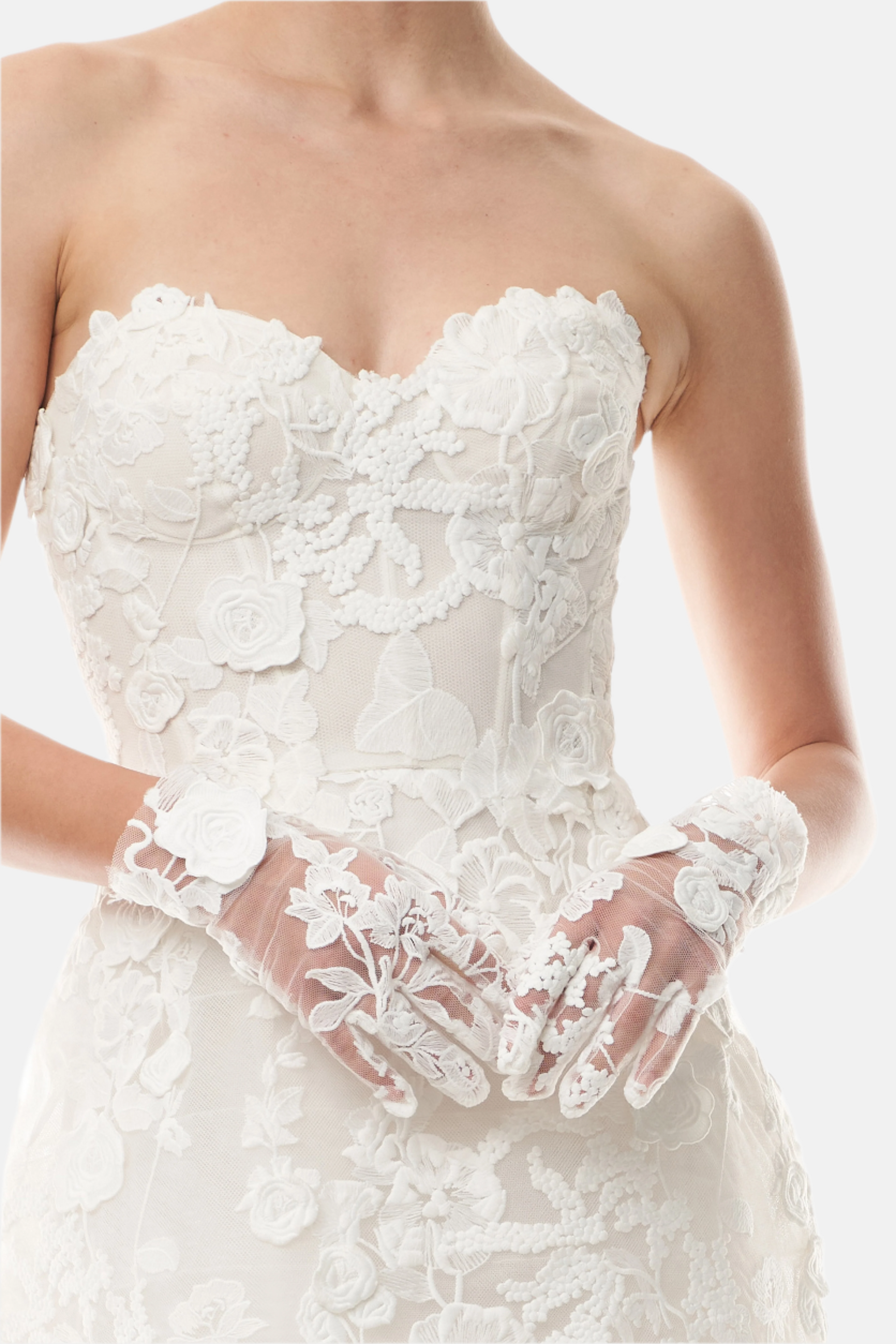 Silk white lace wristlet gloves shown with a lace strapless dress.