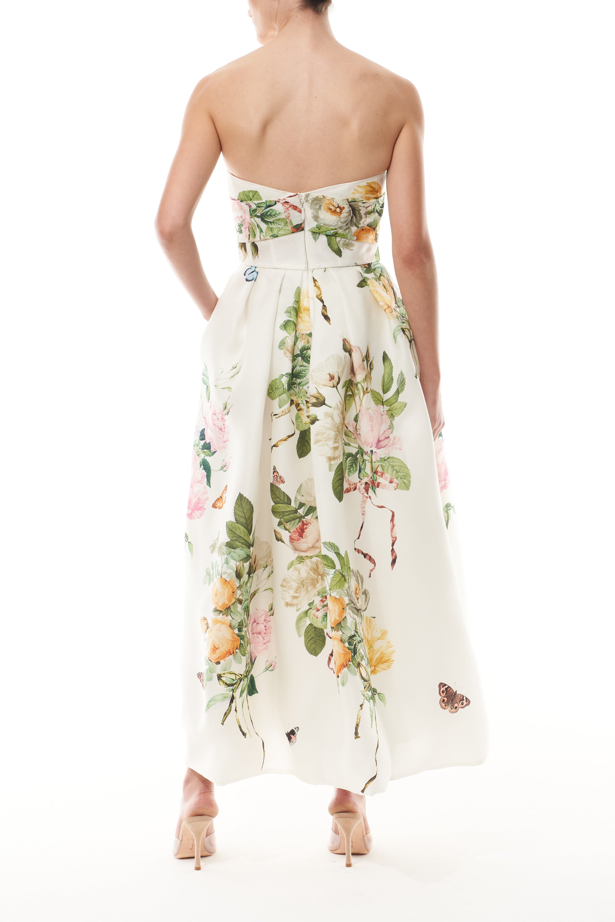 Strapless, tea-length dress in floral printed gazar with draped bodice and pockets - back.