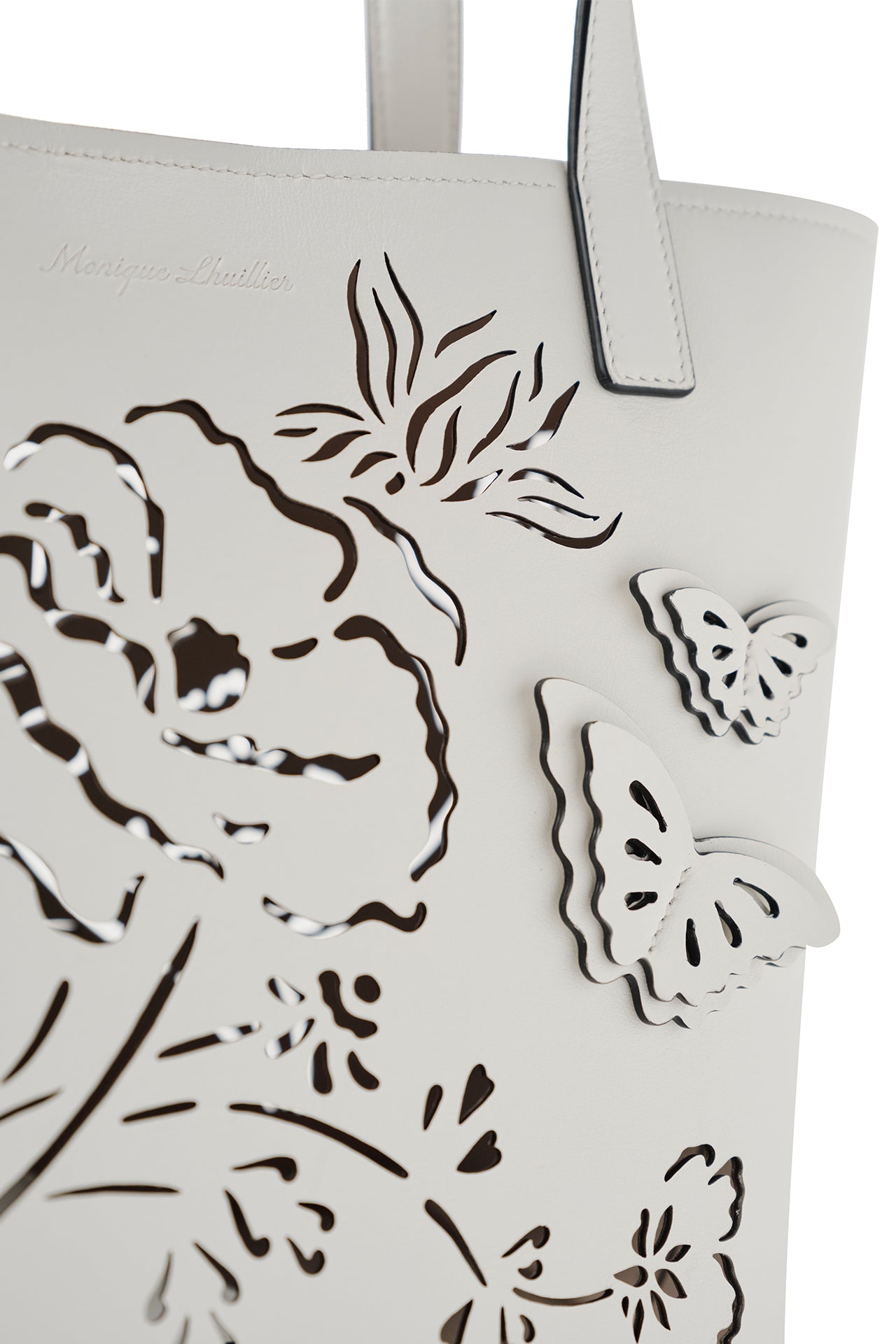 Leather top handle tote bag with laser cut florals, three-dimensional leather butterflies and small zip pouch in Ivory- front detail