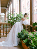 Woman wearing Monique Lhuillier Fall 2022 white floral organza Fernanda ballgown with matching billowed Fernanda sleeves