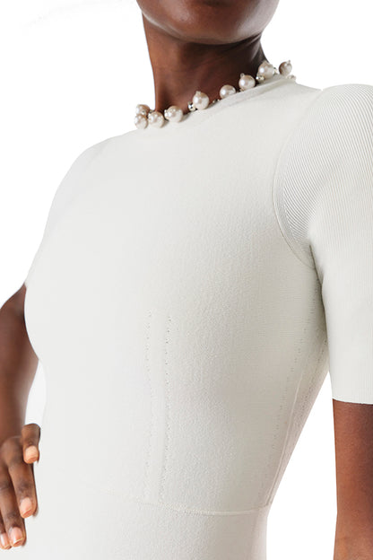 Monique Lhuillier Fall 2024 silk white short sleeve knit mini dress with pearl beaded neckline and flared A-line skirt - pearl detail.