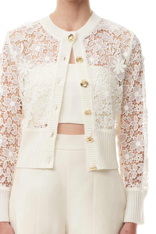 Monique Lhuillier Spring 2025 silk white lace cardigan with gold buttons - front crop.