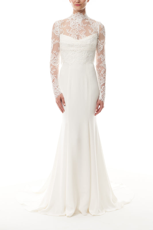 Silk white, long sleeve lace bridal jacket with high neck and hook eye closure at the back.  Shown over silk white satin gown - front.