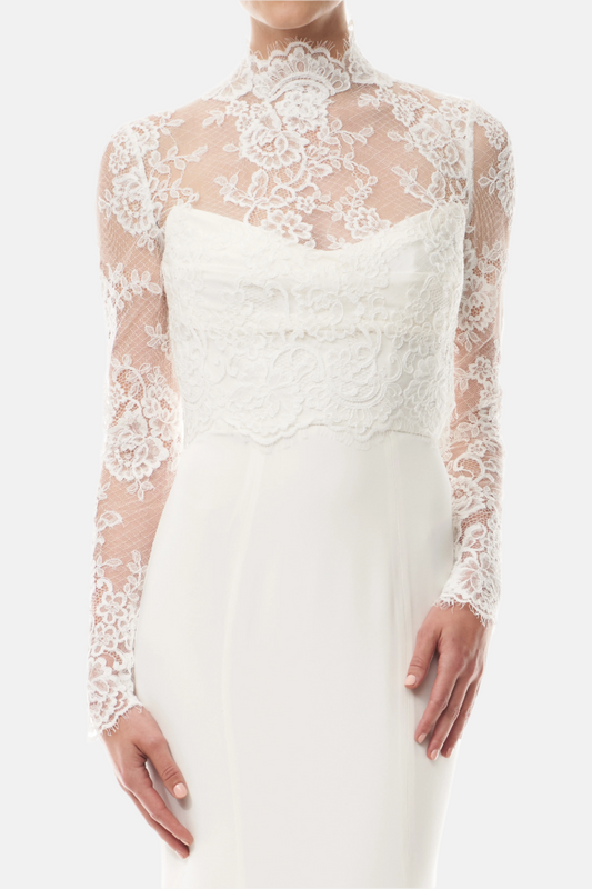 Silk white, long sleeve lace bridal jacket with high neck and hook eye closure at the back.  Shown over silk white satin gown - front crop.