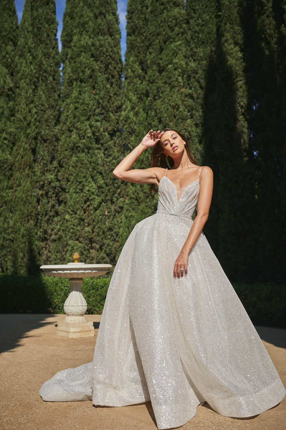 Woman wearing champagne spaghetti strap Monique Lhuillier Spring 2021 Sparkle ballgown