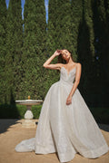 Woman wearing champagne spaghetti strap Monique Lhuillier Spring 2021 Sparkle ballgown