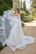 Woman wearing white tulle Monique Lhuillier Spring 2021 Roxy cape with ruffle trim