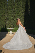 Woman wearing champagne spaghetti strap Monique Lhuillier Spring 2021 Sparkle ballgown