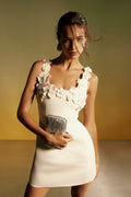 Monique Lhuillier Spring 2026 lookbook image - model wearing Ivory silk wool suiting scoop neck mini dress with floral embroidered neckline