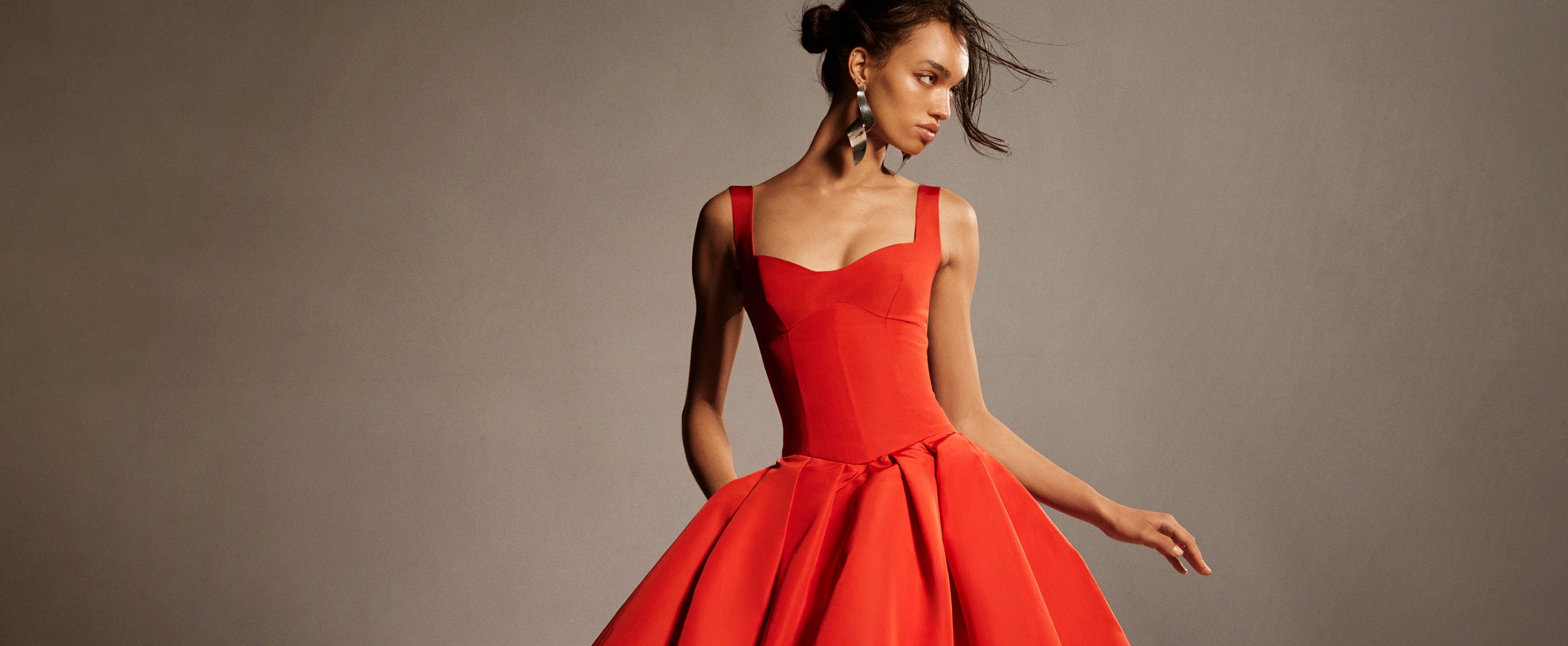 Monique Lhuillier Spring 2026 lookbook image - model wearing Poppy faille scoop neck basque waist pleated ballgown 