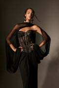 Monique Lhuillier Spring 2026 lookbook image - model wearing noir lace and georgette  corseted dropped waist gown with shawl
