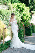 Woman wearing Monique Lhuillier Fall 2020 white fitted sweetheart 3-d floral embroidered Montclair gown with matching long sleeve bolero