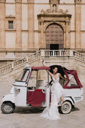 Woman wearing Monique Lhuillier Spring 2023 Bliss white and multi colored floral print v-neck trumpet tulle BL23110 gown
