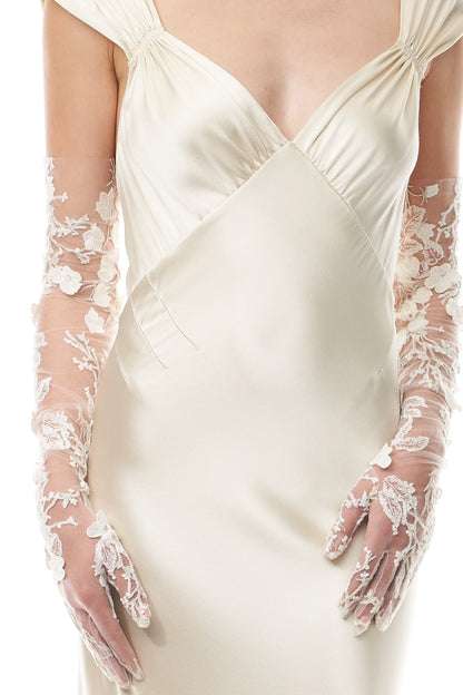 Opera length tulle gloves in metallic ivory floral embroidery.  Shown with an ivory satin gown.