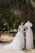 Woman wearing Monique Lhuillier Spring 2023 Bliss white strapless embroidered BL23105 ballgown with matching embroidered BL23170 jacket