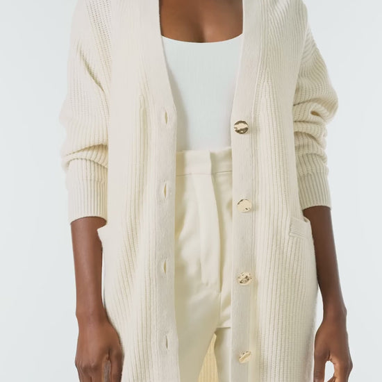Monique Lhuillier Spring 2024 white cashmere long chunky cardigan with gold buttons - video.