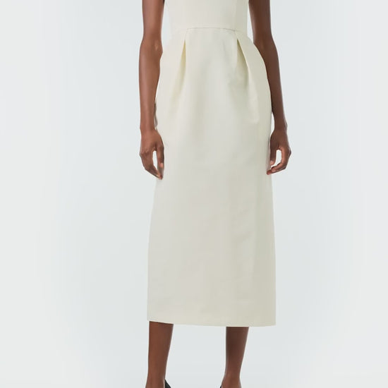 Monique Lhuillier Fall 2024 sleeveless, scoop neck cocktail dress with pearl embroidered neckline, low back, pockets, and natural waist seam - video.