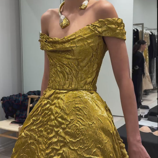 Monique Lhuillier Fall 2025 gold lame rose jaquard  Off-the-shoulder draped bodice ball gown behind the scenes footage at atelier 