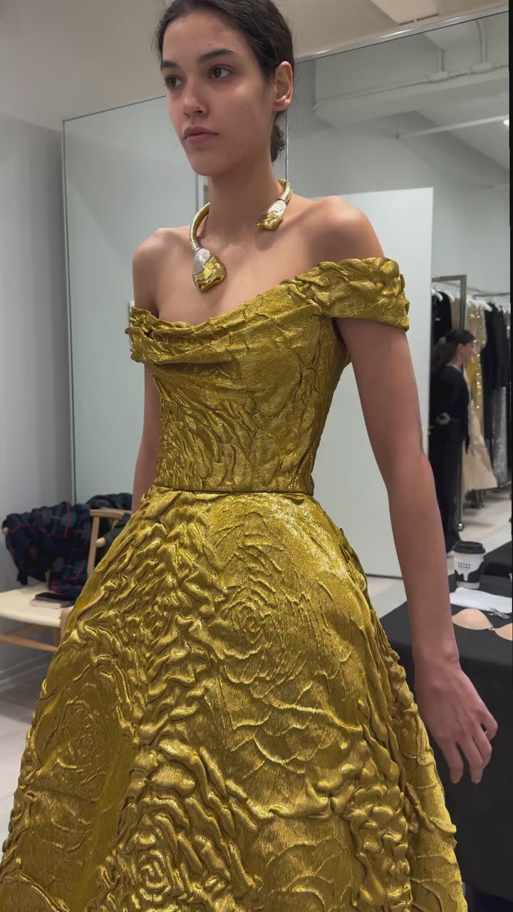Monique Lhuillier Fall 2025 gold lame rose jaquard  Off-the-shoulder draped bodice ball gown behind the scenes footage at atelier 
