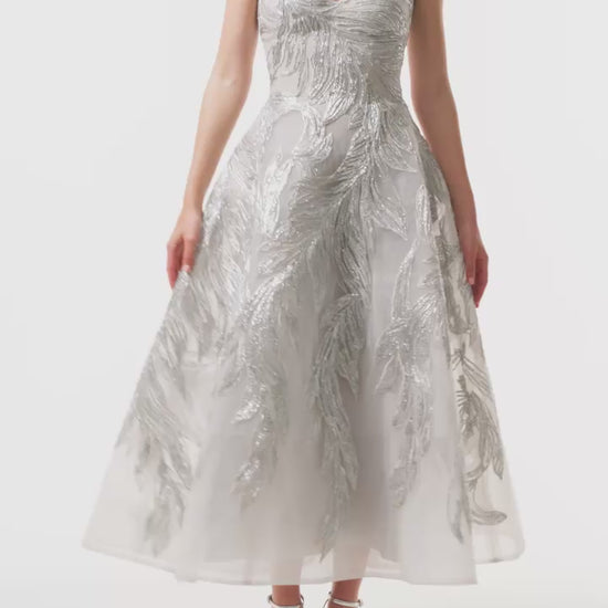 Monique Lhuillier Fall 2025 strapless dress with tea-length skirt and sweetheart neckline in silver feather embroidery - video.