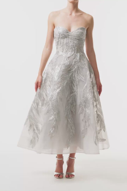 Monique Lhuillier Fall 2025 strapless dress with tea-length skirt and sweetheart neckline in silver feather embroidery - video.
