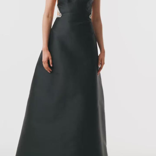 Monique Lhuillier Fall 2025 floor length ball gown with cut-out details and crystal embroidered piping in noir mikado - video.
