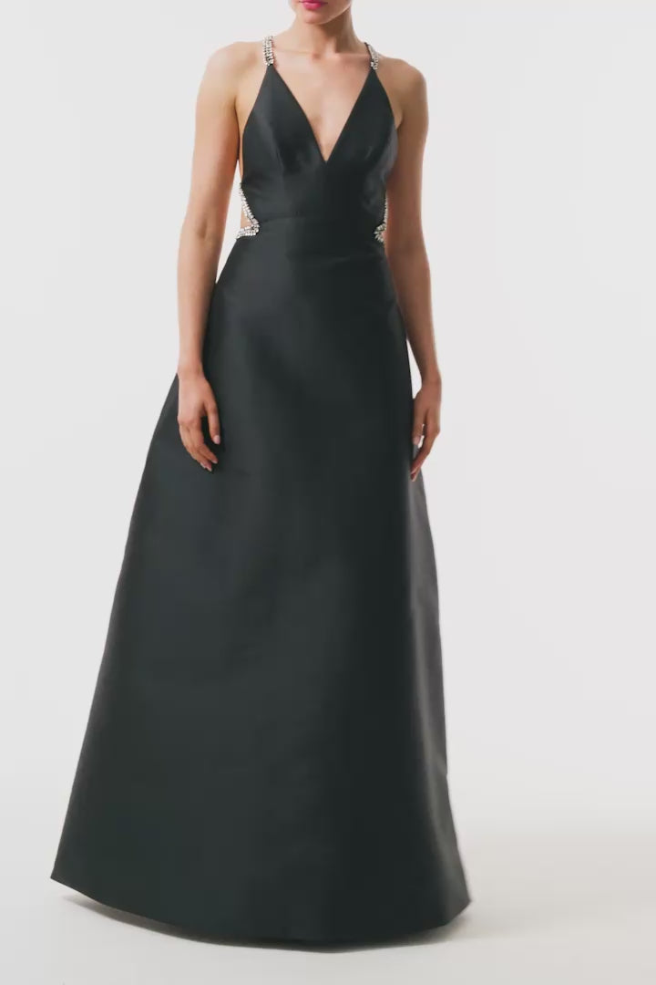 Monique Lhuillier Fall 2025 floor length ball gown with cut-out details and crystal embroidered piping in noir mikado - video.