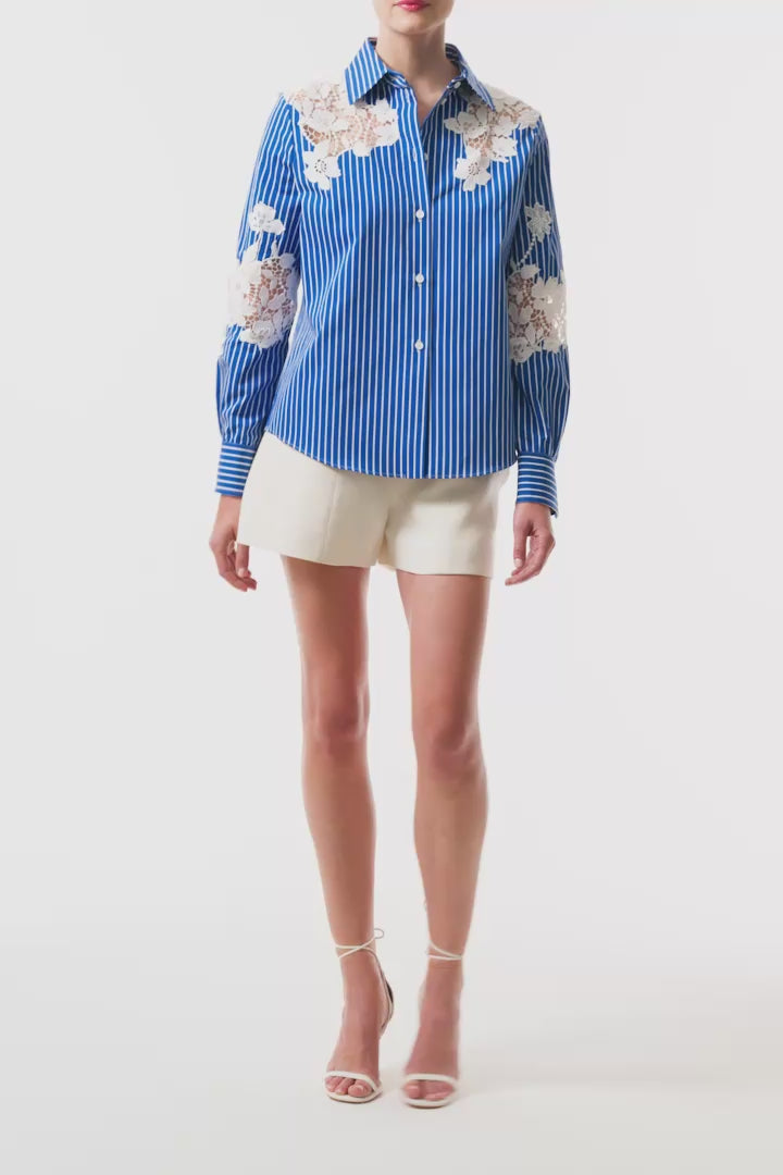 Monique Lhuillier Spring 2025 Long sleeve, button front collared striped shirt with lace detailing in Nautical Blue poplin with White lace details  - video.